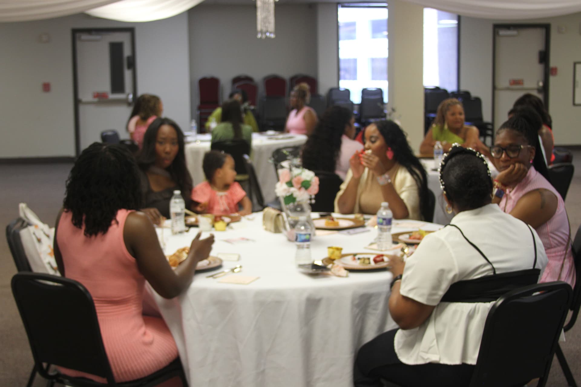 Women sharing a meal and conversation around a table at an HMRAN brunch