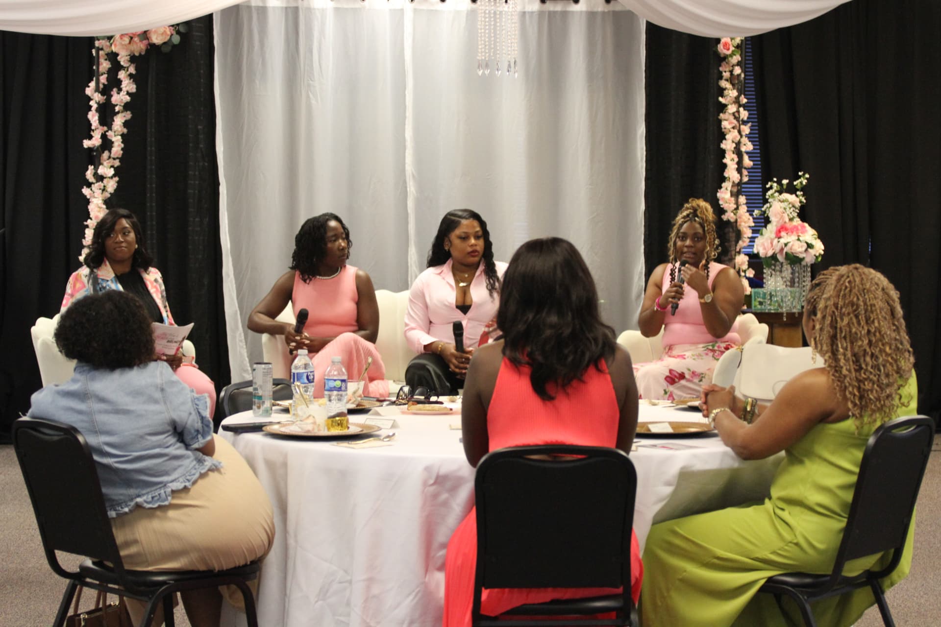 Panel of women sharing with guests around a brunch table